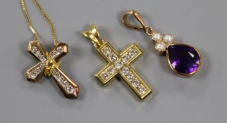 An 18ct gold and diamond cross pendant, one other diamond cross pendant on 14k chain and a 9ct