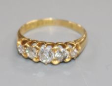 An early 20th century 18ct gold and graduated five stone diamond ring, size J.
