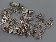 A silver charm bracelet and assorted loose charms.
