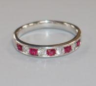 A modern 18ct white gold, nine stone ruby and diamond half eternity ring, size Q