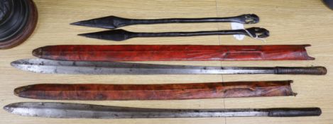 Two ebony spears and two Masai swords with scabbards