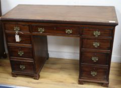 An Edwardian mahogany nine drawer desk W.110cm