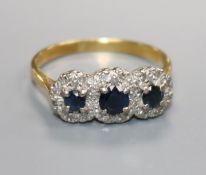 A triple cluster diamond and sapphire ring, 18ct gold shank