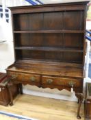 An 18th century oak dresser with boarded plate rack over