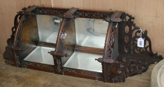 An Edwardian fretwork corner mirrored shelf unit W.35cm