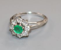 An emerald and diamond cluster ring, 18ct white gold pierced shank, size P.