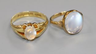 An Edwardian 15ct gold and claw set moonstone ring and a lter 14k gold moonstone ring.