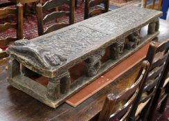 An early 20th century Cameroon carved wood child's bed w.145cm