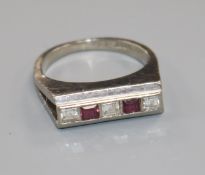 An 18ct white gold and channel set five stone ruby and diamond ring, size M.