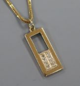 A 9ct gold and diamond pendant on and 18ct gold chain, pendant 23mm.