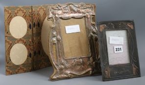 An Art Nouveau copper photo frame, an Arts & Crafts copper photo frame and a Liberty & Co fabric