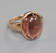 A 14k gold and cabochon pink gem ring, size Q/R.