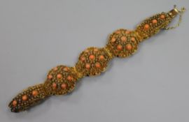 A filligree gilt white metal and coral bead set bracelet, approx. 17cm.
