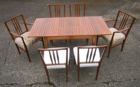 A Gordon Russell teak extending dining table and six chairs (4+2 carvers)