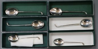 Six boxed silver "golf club" handled teaspoons.