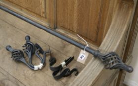 A wrought iron curtain pole and curtains Pole width approx. 290cm