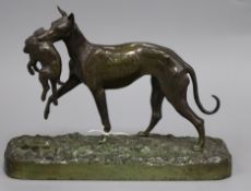 A cast iron (not bronze) figure of a greyhound holding a hare, height 61cm