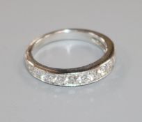 A modern 18ct white gold and graduated fifteen stone diamond half eternity ring, size O.