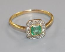 A mid 20th century 18ct gold, emerald and diamond cluster tablet ring, size U.