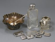 Twelve items of small silver and plated ware including six stamp "envelopes", napkin ring, spoon