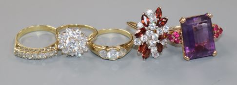 Four assorted 9ct gold and gem set dress rings and a 14k gold gem set dress ring.