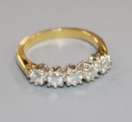 An 18ct gold and five stone diamond half hoop ring, size P.