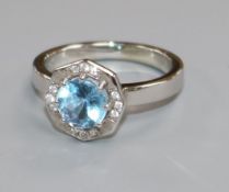 A modern 14ct white gold, aquamarine and diamond octagonal cluster ring, size Q/R.