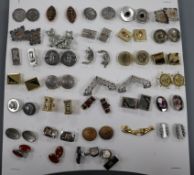 A small collection of assorted cufflinks including silver.