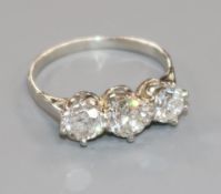 A platinum and three stone diamond ring, with an approximate total weight of 1.50cts, size O.