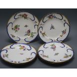 A set of six Sevres plates, painted in colours, with bouquets of flowers, surrounded by blue scrolls