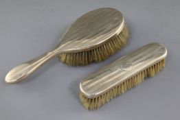 Two George V silver engine turned dressing table brushes.