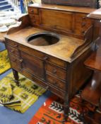 A Regency mahogany washstand with cistern compartment and basin recess W.94cm.