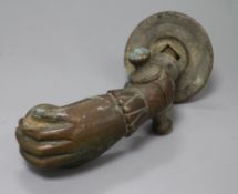 A large bronze hand door knocker