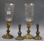 A pair of Victorian gilt metal candlesticks, cast and chased with foliage, with etched campana