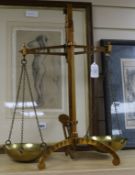 A brass balance on tripod base, with two circular chained pans, by Degrave & Co. height 54cmex