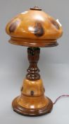 A fruitwood lamp, on circular foot, with vari baluster stem and domed wood shade, overall height