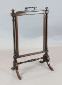 A late Victorian ebonised and thuyawood cheval fire screen with mirrored plate, W.61cm