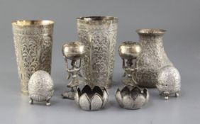 Two Indian white metal embossed beaker vases, six Indian condiments and one other Indian vase.