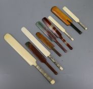 Nine assorted miniature cricket bats, including two ivory letter openers, three agate, two wooden