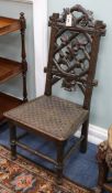 A 19th century Black Forest oak chair, with rustic trellis and grapevine back, the solid carved