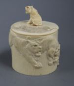 A Japanese Meiji ivory tusk box and cover, carved all round with tigers, the cover with seated tiger