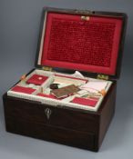 A Victorian rosewood rectangular work box, enclosing a fitted interior with a drawer in the base,