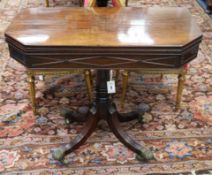 A Regency mahogany card table, with canted corners, on plain column and ring turned support with