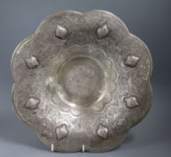 A Persian engraved white metal cusped circular dish, on three ball feet, 32.5cm.