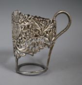 A Persian white metal cup holder, 11cm.