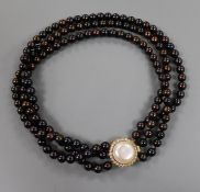 A triple strand cultured "chocolate" pearl choker necklace with 18ct gold, mabe pearl and diamond