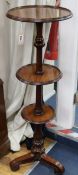 A late Victorian mahogany three tier dumb waiter, on turned partly reeded support, on scrolled