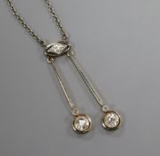 A 1920's/1930's white and yellow metal, three stone diamond set double drop pendant necklace,