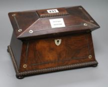 A William IV rosewood sarcophagus shaped tea caddy, with gadrooned borders inlaid with mother of