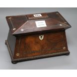 A William IV rosewood sarcophagus shaped tea caddy, with gadrooned borders inlaid with mother of